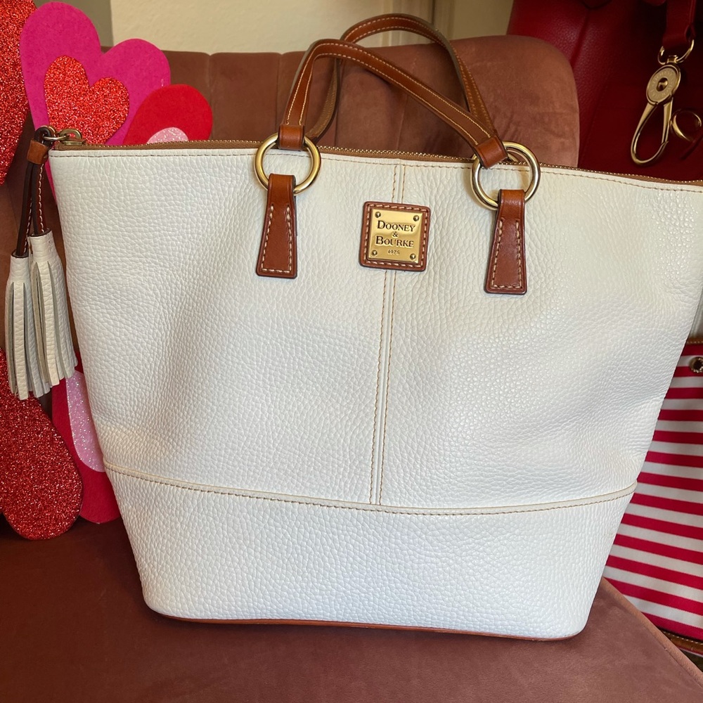 Dooney and Bourke Pebble leather cream Tobi tote. Brass hard ware. Gently used